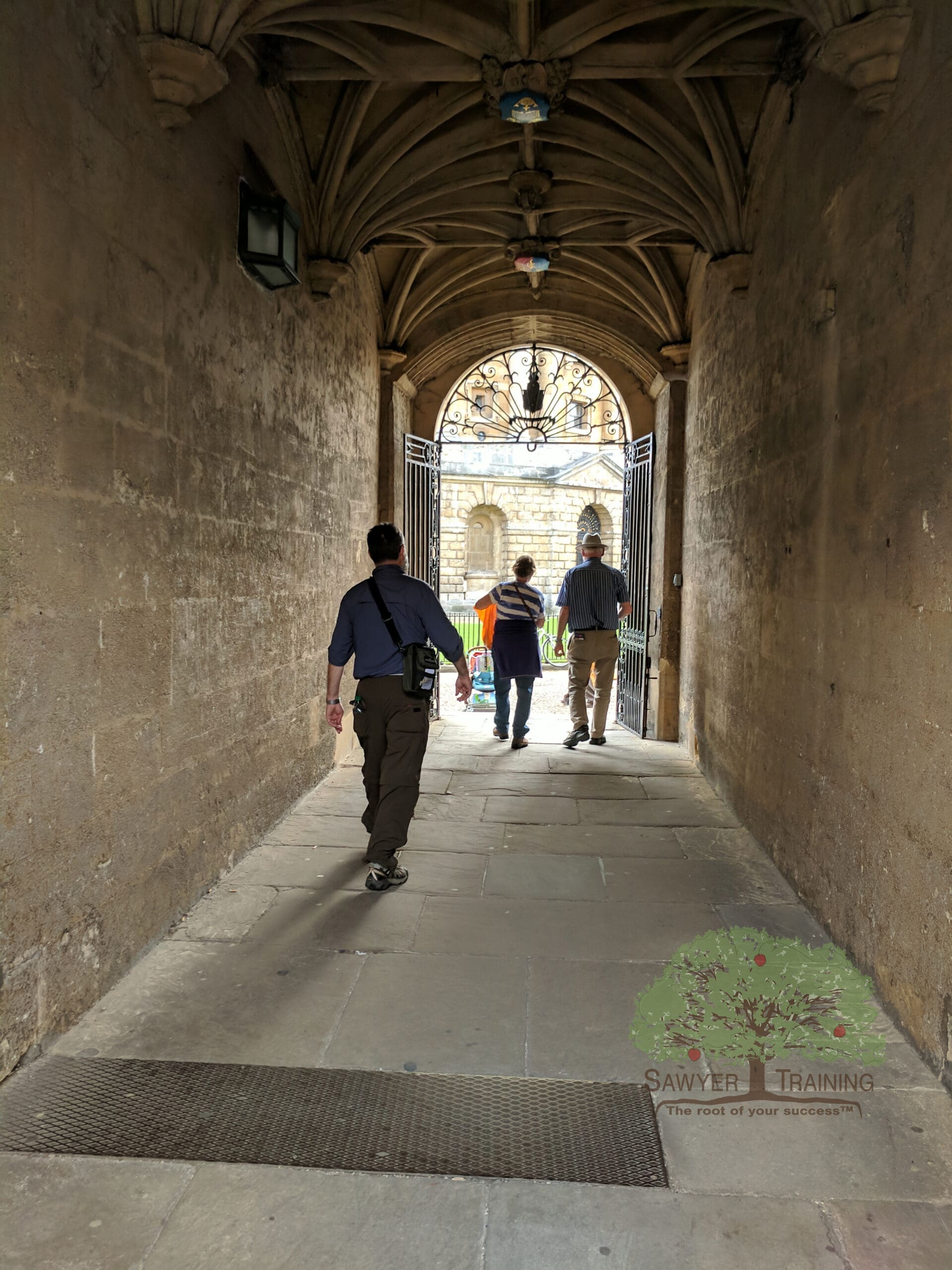 Passage in Oxford George Sawyer walking through stone walkway at Oxford